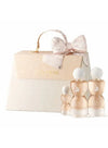 Elegant perfume gift set with four glass fragrance bottles and a luxury cream-colored box