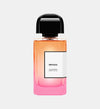 Impadia Eau de Parfum bottle with pink gradient glass and black cap on white background
