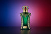 Luxurious green and gold perfume bottle with ornate crown cap on colorful background