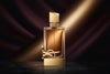 Luxury perfume bottle with gold accents on a marble surface, dramatic dark gradient background